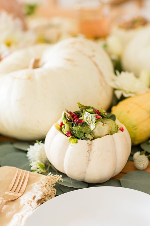 Pumpkin bowls that hold Thanksgiving side dishes.