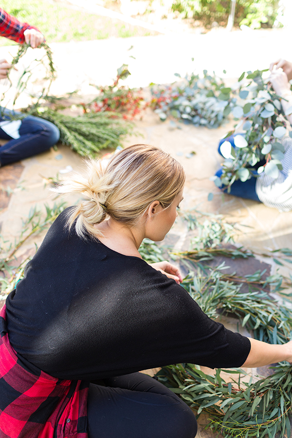 DIY your own holiday wreath with fresh greens and blooms.