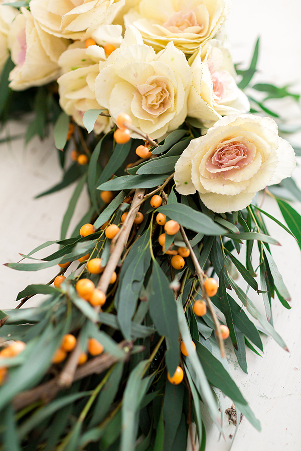 Fresh garden roses on a holiday wreath.