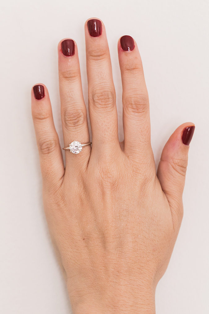 Solitaire diamond ring + holiday red mani