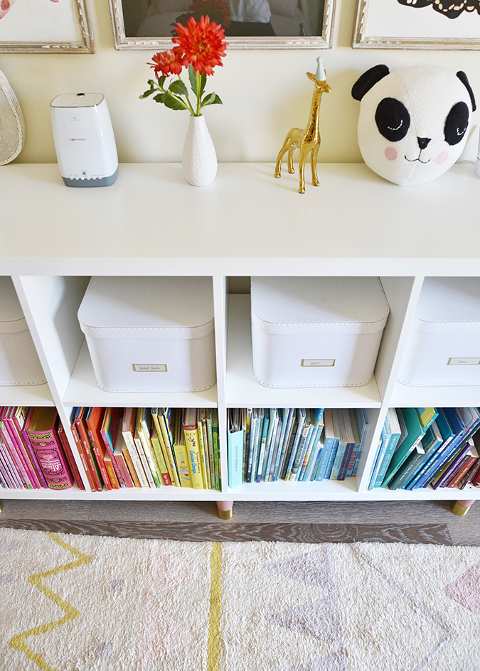 color coded bookshelf in a kids room